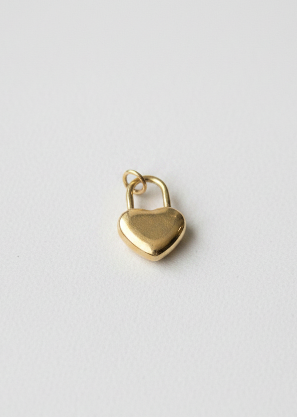 Gold heart lock charm on clean white background