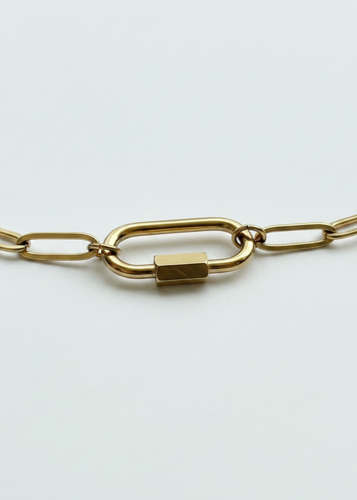 Gold carabiner clasp close-up on white background