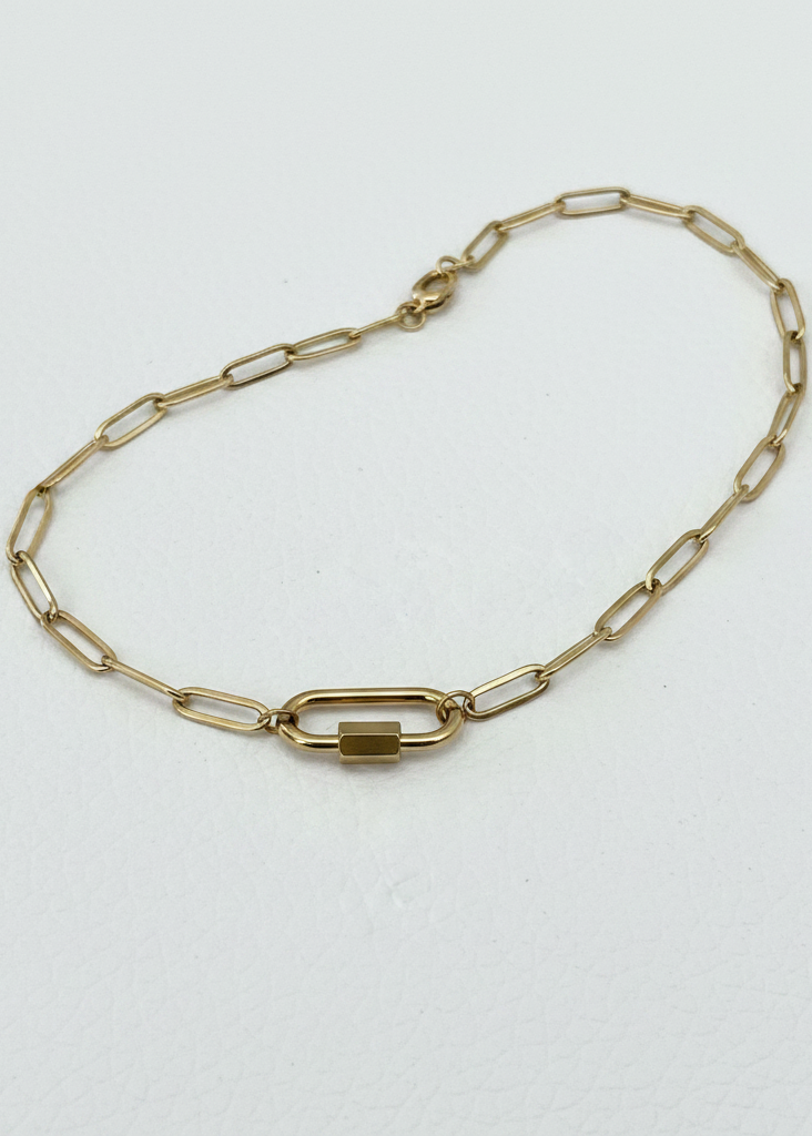 Gold paperclip carabiner necklace on white background